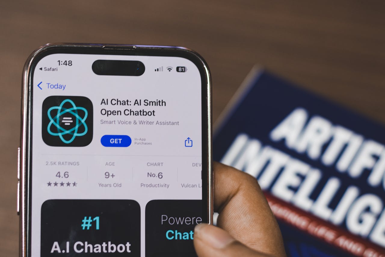 Services-01 Hand holding a smartphone with AI chatbot app, emphasizing artificial intelligence and technology.